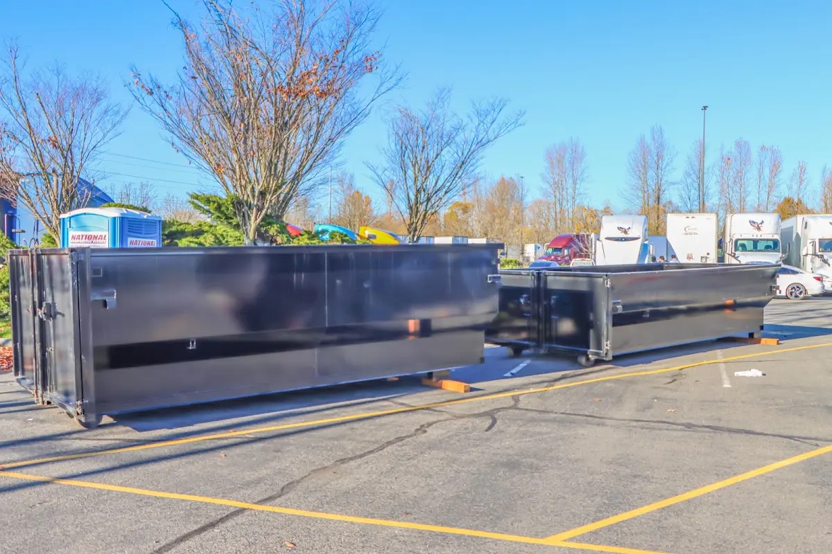 Professional dumpster rental service with roll-off container on residential driveway in Mascoutah